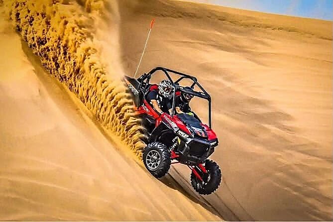 Buggy climbing a steep dune